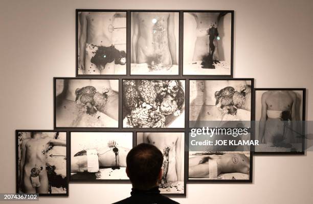 Graphic content / An employee sits in front of a black and white series by Hermann Nitsch, a leading figure of Viennese Actionism, whose art...