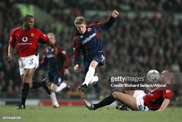 February 11: Juninho of Middlesbrough, Quinton Fortune of Manchester United and Mikael Silvestre of Manchester United challenge during the Premier...