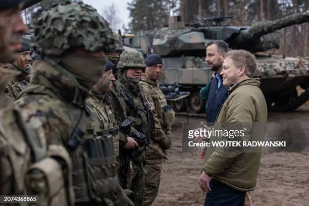 Britain's Secretary of Defense Grant Shapps and Polish Defence Minister Wladyslaw Kosiniak-Kamysz greet and chat with British and Polish troops after...