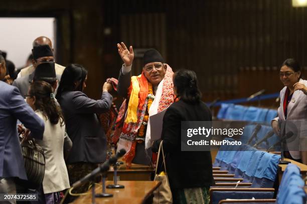 Pushpa Kamal Dahal , the Prime Minister of Nepal, is waving at the media while covered in floral garlands after securing his third vote of confidence...