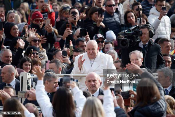 Pope Francis is waving to the faithful as he attends his general audience in Saint Peter's Square, Vatican City, on March 13, 2024.