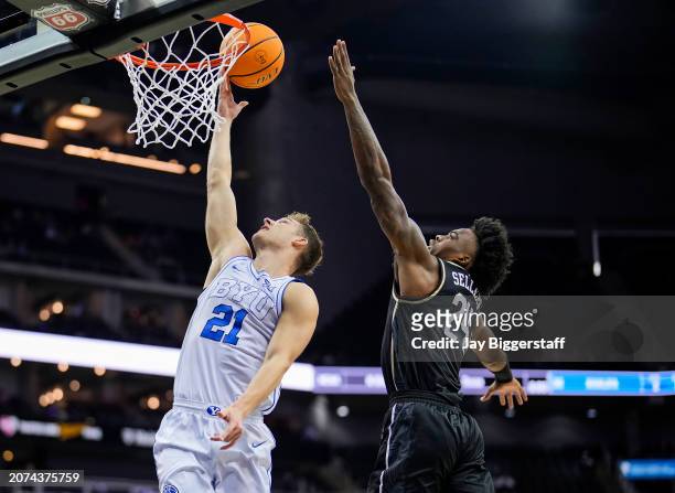 Trevin Knell of the Brigham Young Cougars shoots against Jaylin Sellers of the UCF Knights during the first half of the game in the second round of...