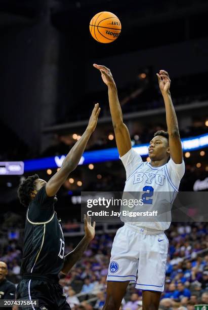 Jaxson Robinson of the Brigham Young Cougars shoots against Marchelus Avery of the UCF Knights during the first half of the game in the second round...