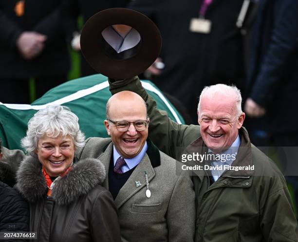 Gloucestershire , United Kingdom - 13 March 2024; Trainer Willie Mullins, right, celebrates with winning connections and his wife Jackie, left, after...