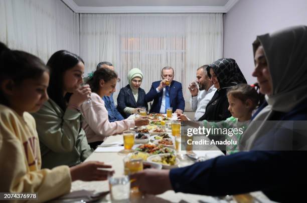 Turkish President Recep Tayyip Erdogan and his wife Emine Erdogan attend an iftar dinner at the house of Ali Osman Tas and his family in Altindag...