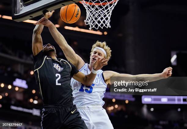 Shemarri Allen of the UCF Knights is fouled by Richie Saunders of the Brigham Young Cougars during the second half of the game in the second round of...