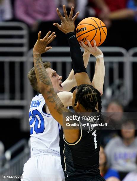 Spencer Johnson of the Brigham Young Cougars is fooled while shooting against Antwann Jones of the UCF Knights during the second half of the game in...