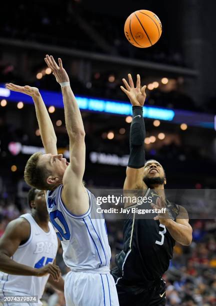 Darius Johnson of the UCF Knights shoots against Spencer Johnson of the Brigham Young Cougars during the second half of the game in the second round...