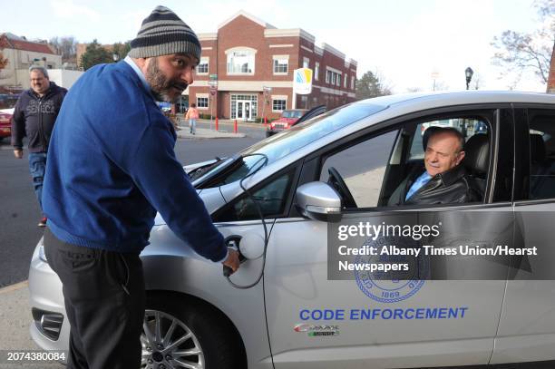 Treasurer Peter Frangie, left, and Cohoes Mayor George Primeau check out the new vehicles during the announcement of the acquisition of the 2 Ford...