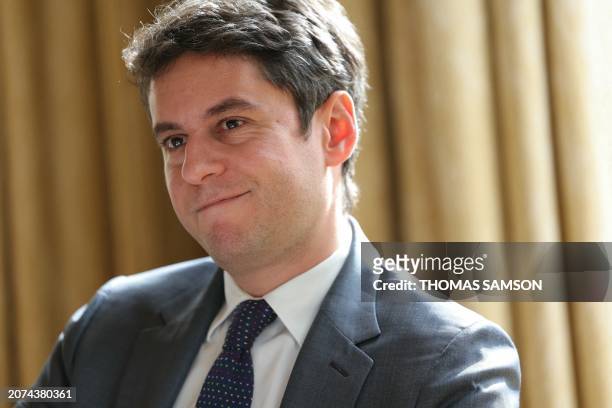 France's Prime Minister Gabriel Attal smiles in his office at the Hotel Matignon, in Paris, on March 13, 2024. Secularism is "threatened more than...