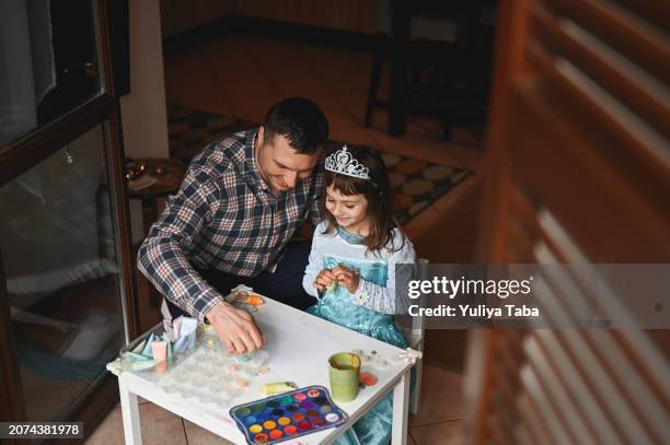 cute young family painting with watercolors. - princess stock pictures, royalty-free photos & images