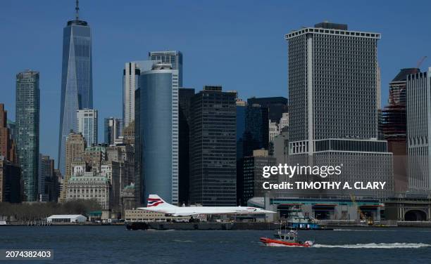 The Intrepid Museum's iconic British Airways Concorde G-BOAD supersonic jet passes by Lower Manhattan, in New York on March 13, 2024 as it makes its...
