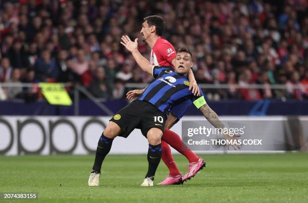 Atletico Madrid's Montenegrin defender Stefan Savic vies with Inter Milan's Argentine forward Lautaro Martinez during the UEFA Champions League last...