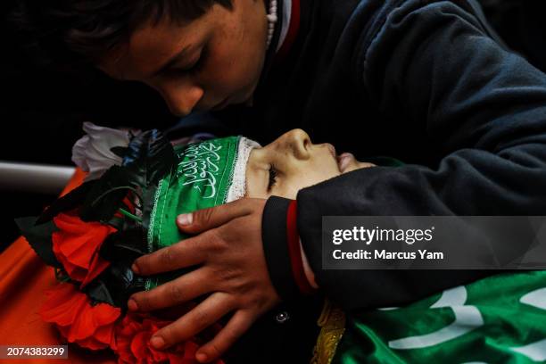 Young boy bids farewell to Amro Najjar who was killed by Israeli forces during an incursion the day before, during a funeral procession at the local...