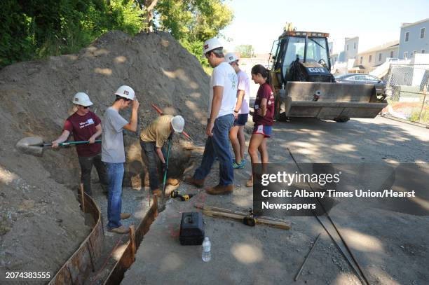 Albany Medical College first year students work on building a retaining wall at the Habitat for Humanity Sheridan Hollow build on Saturday Aug. 8,...