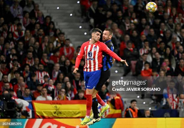 Atletico Madrid's Spanish forward Alvaro Morata jumps for the ball with Inter Milan's Dutch defender Stefan de Vrij during the UEFA Champions League...