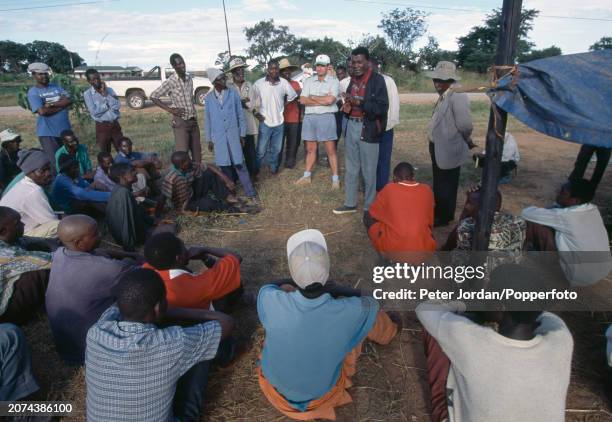White farmer Derek Nicolle, confronting a group of black men at his farm in Banket, Zimbabwe, circa March 2000.