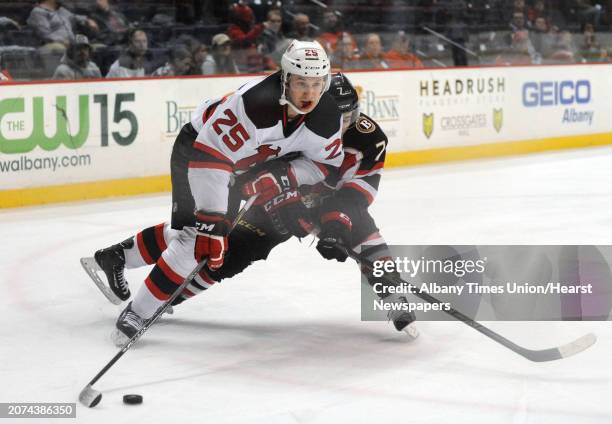 Devil Nick Lappin and Binghamton's Chris Carlisle go after the puck during their hockey game at the Times Union Center on Wednesday April 13, 2016 in...