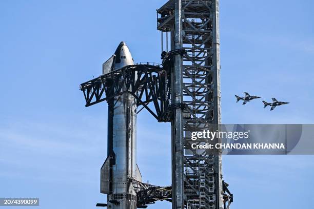 Billionaire businessman and pilot Jared Isaacman flies in formation aboard a fighter jet over the SpaceX Starship spacecraft, before his third test...
