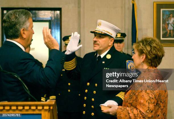 Times Union Staff Photo by Michael P. Farrell Albany Mayor Gerald D. Jennings swears in Robert C. Forezzi Sr. To the position of Fire Chief as Daphne...