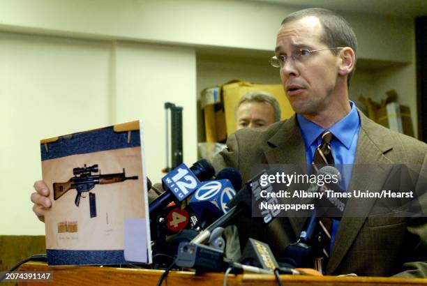 Times Union Staff Photo--Michael P. Farrell-- Chautauqua County District Attorney David W. Foley holds up a photograph of the rife Phillips used when...