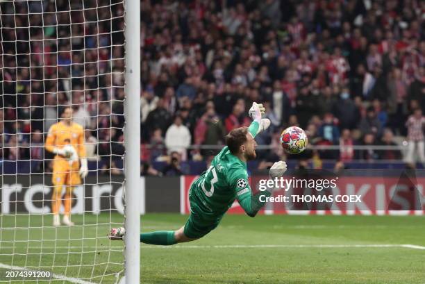 Atletico Madrid's Slovenian goalkeeper Jan Oblak stops the ball during the penalty shoot-out session during the UEFA Champions League last 16 second...