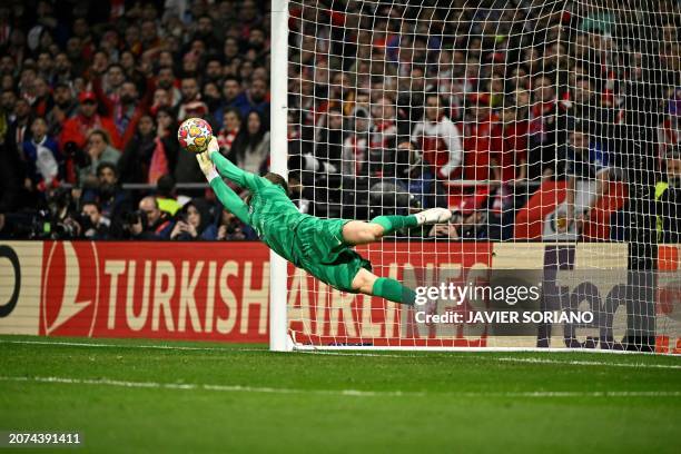 Atletico Madrid's Slovenian goalkeeper Jan Oblak stops the ball during the penalty shoot-out session during the UEFA Champions League last 16 second...