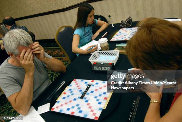 Times Union Staff Photo By Michael P. Farrell--John Morse of Delmar concentrates over his avalible letters as he plays Jan Dixson of Newark ,...