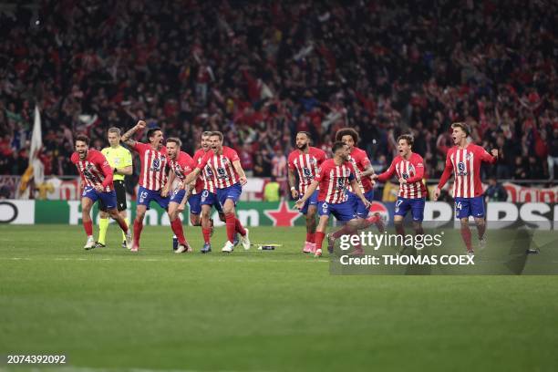 Atletico Madrid's players celebrate victory at the end of the UEFA Champions League last 16 second leg football match between Club Atletico de Madrid...