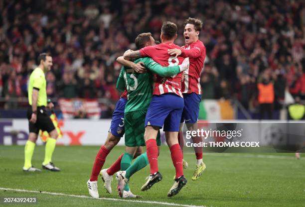 Atletico Madrid's players celebrate victory at the end of the UEFA Champions League last 16 second leg football match between Club Atletico de Madrid...
