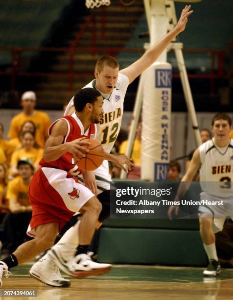 Photo by Michael P. Farrell/Albany Times Union via Getty Images -- Albany , New York -- -- Siena's Josh Duell guards Marist's David Denezin during...