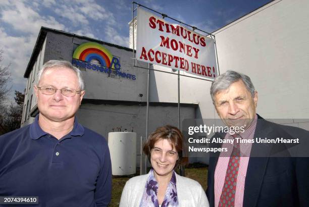 Richard Marriner , Linda Guerin and Richard Cunningham, President, of Passonno Paints in front of a sign reading "Stimulus Money Accepted Here" in...