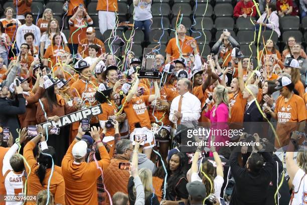 Streamers fall as the Texas Longhorns lift up the championship trophy after winning the women's Big 12 tournament final between the Iowa State...