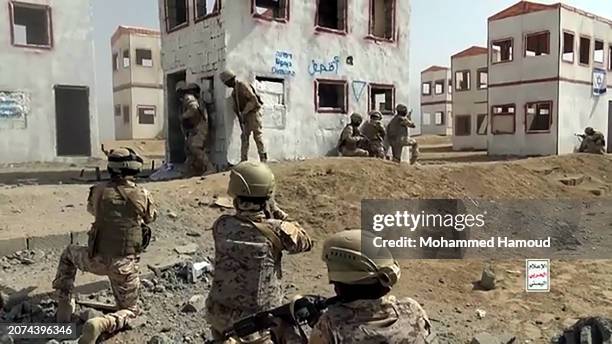 In this handout image provided by the Houthi media center, fighters participate in a military attack exercise on March 10 in Sana'a, Yemen. The...