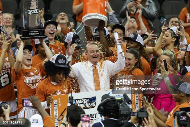 Texas Longhorn head coach Vic Schaefer has confetti poured on him after winning the women's Big 12 tournament final against the Iowa State Cyclones...