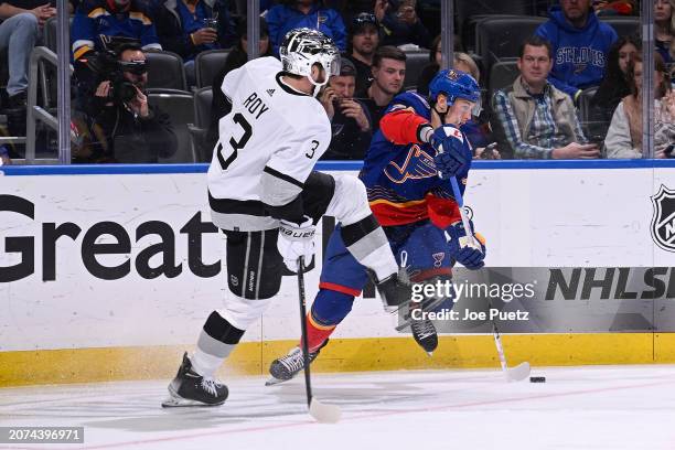 Matt Roy of the Los Angeles Kings pressures Zack Bolduc of the St. Louis Blues on March 13, 2024 at the Enterprise Center in St. Louis, Missouri.