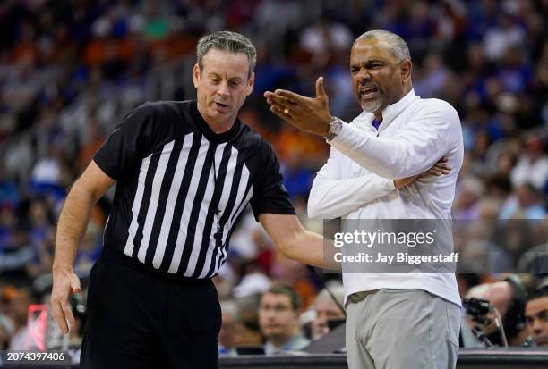 Head coach Jerome Tang of the Kansas State Wildcats talks with referee Doug Sirmons during the first half against the Texas Longhorns in the second...