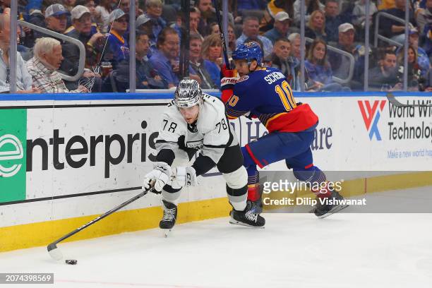 Alex Laferriere of the Los Angeles Kings beats Brayden Schenn of the St. Louis Blues to the puck in the second period at Enterprise Center on March...