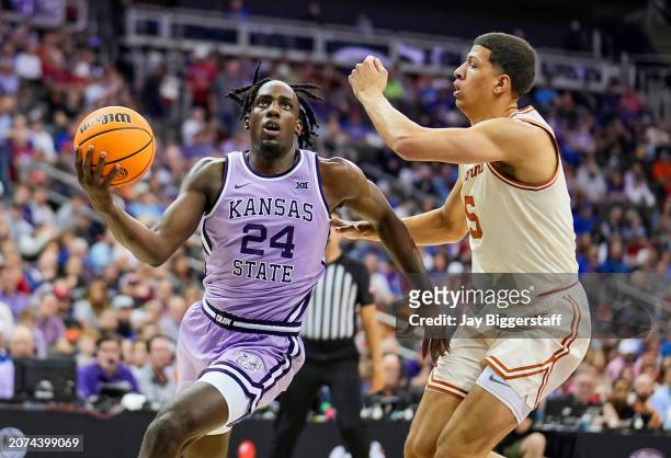 Arthur Kaluma of the Kansas State Wildcats drives against Kadin Shedrick of the Texas Longhorns during the second half of the game in the second...