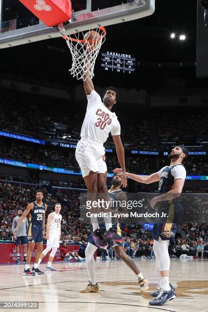 Damian Jones of the Cleveland Cavaliers dunks the ball during the game against the New Orleans Pelicans on March 13, 2024 at the Smoothie King Center...