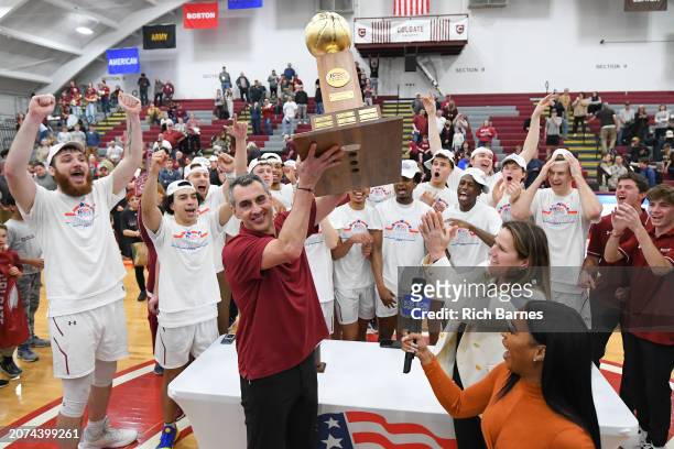 Head coach Matt Langel of the Colgate Raiders holds the Patriot League Basketball Tournament Championship trophy following the game against the...
