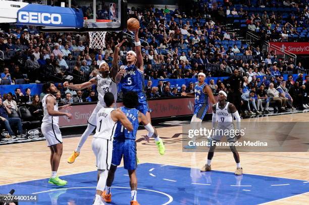 Paolo Banchero of the Orlando Magic drives to the basket during the game against the Brooklyn Nets on March 13, 2024 at the Kia Center in Orlando,...