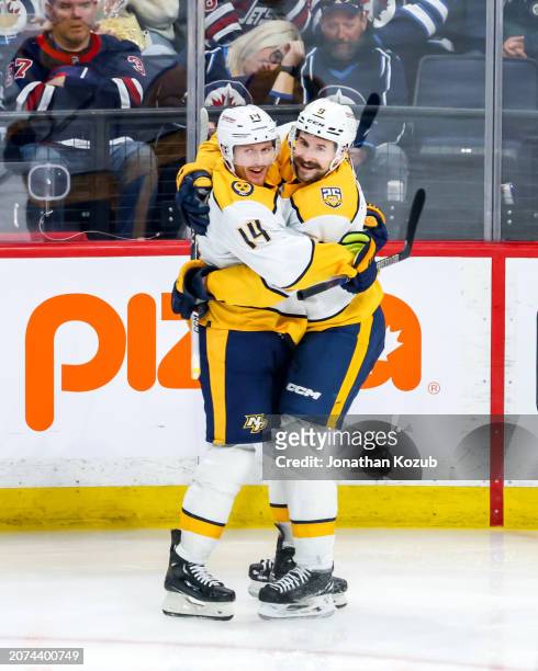 Gustav Nyquist and Filip Forsberg of the Nashville Predators celebrate a third period goal against the Winnipeg Jets at the Canada Life Centre on...