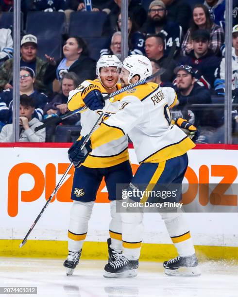 Gustav Nyquist and Filip Forsberg of the Nashville Predators celebrate a third period goal against the Winnipeg Jets at the Canada Life Centre on...