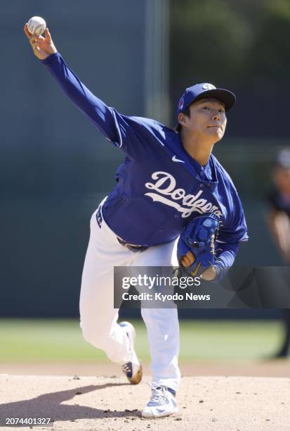 Yoshinobu Yamamoto of the Los Angeles Dodgers pitches in a spring training baseball game against the Seattle Mariners in Glendale, Arizona, on March...