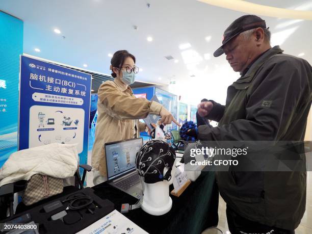 Visitors are experiencing the "brain-computer interface Active rehabilitation System" at the Example Center of Services for the Disabled in Beijing,...