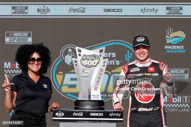 Christopher Bell, driver of the Rheem Toyota, poses with Latasha Causey, president of Phoenix Raceway in victory lane after winning the NASCAR Cup...