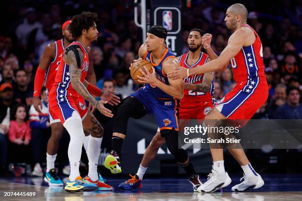 Josh Hart of the New York Knicks looks to pass as Kelly Oubre Jr. #9, Cameron Payne, and Nicolas Batum of the Philadelphia 76ers defend during the...