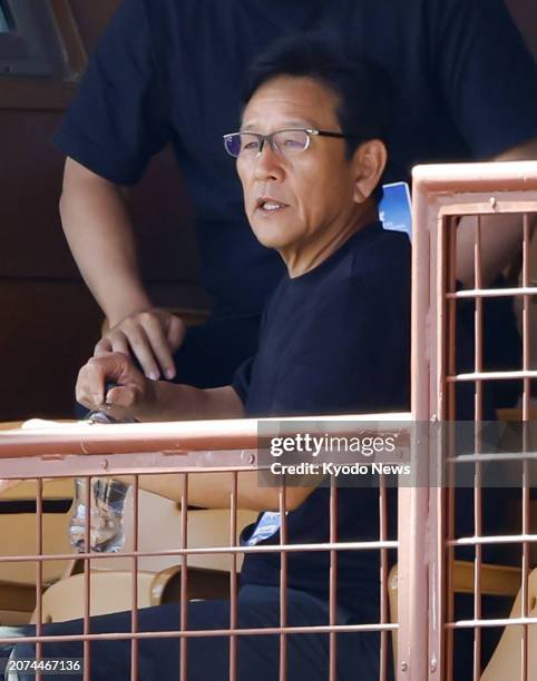 Former Nippon Ham Fighters and Samurai Japan manager Hideki Kuriyama watches a spring training game between the Los Angeles Dodgers and the Seattle...