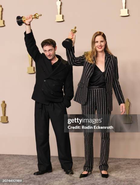 Arthur Harari and Justine Triet, winners of Original Screenplay award for 'Anatomy of Fall' pose in the press room during the 96th Annual Academy...